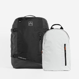 A studio shot of the adventure bag in All Black / Off White ultra light backpack