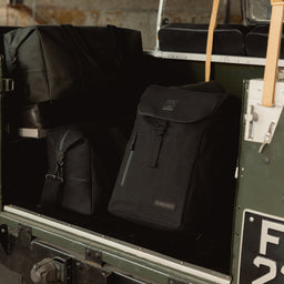 The canvas collection of bags in the boot of the car including the Backpack 20L in All Black