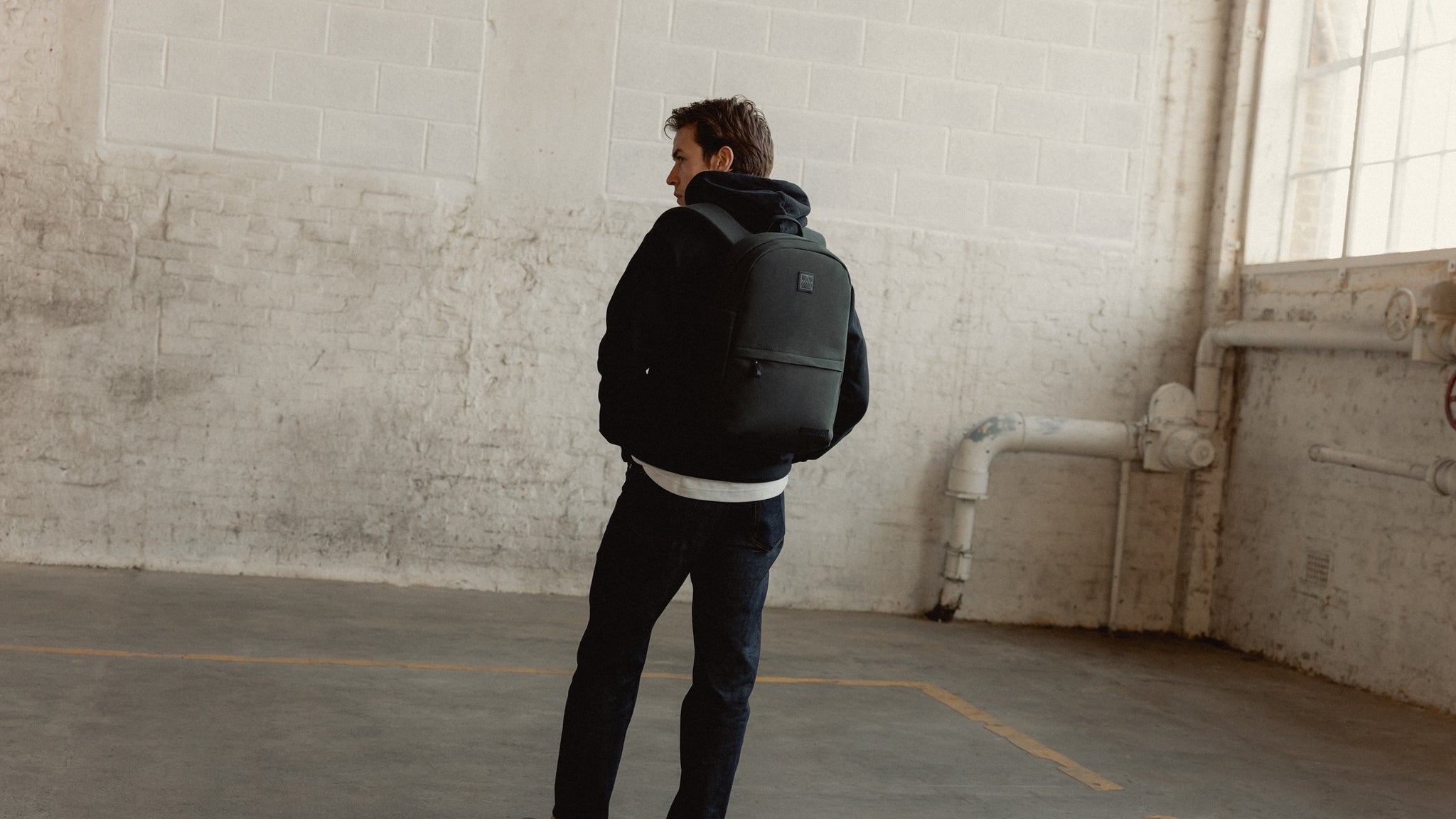 a man wearing a Classic backpack 15L in pirate on his back