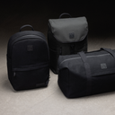 A creative studio shot of the canvas collection including the Classic Backpack 15L in All Black