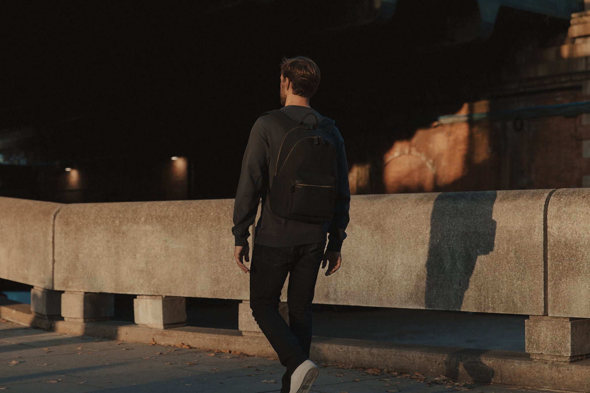 Man walking with Commuter backpack at night