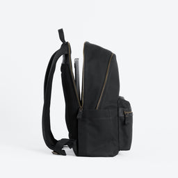 The Commuter Backpack in Black and Gold open with the laptop compartment