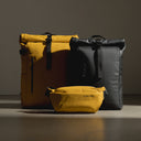 a studio shot of a roll top and a Yellow crossbody creative