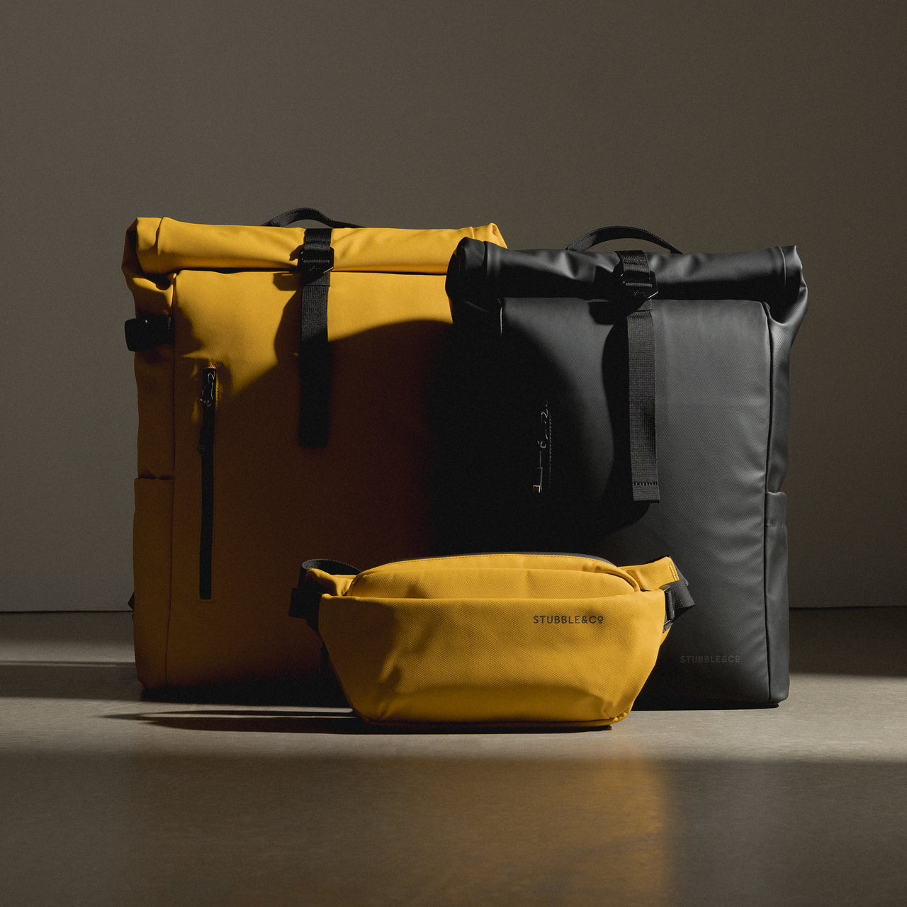 a studio shot of a roll top and a Yellow crossbody creative