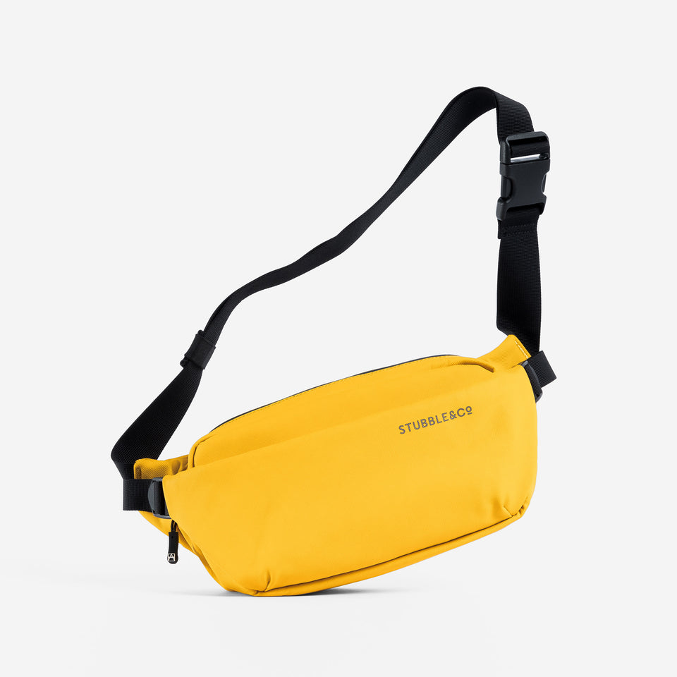 a studio shot of a Yellow crossbody with the adjustablestrap up