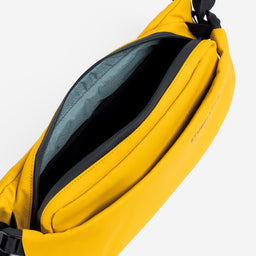 a studio shot of the interior and blue lining in the Yellow crossbody