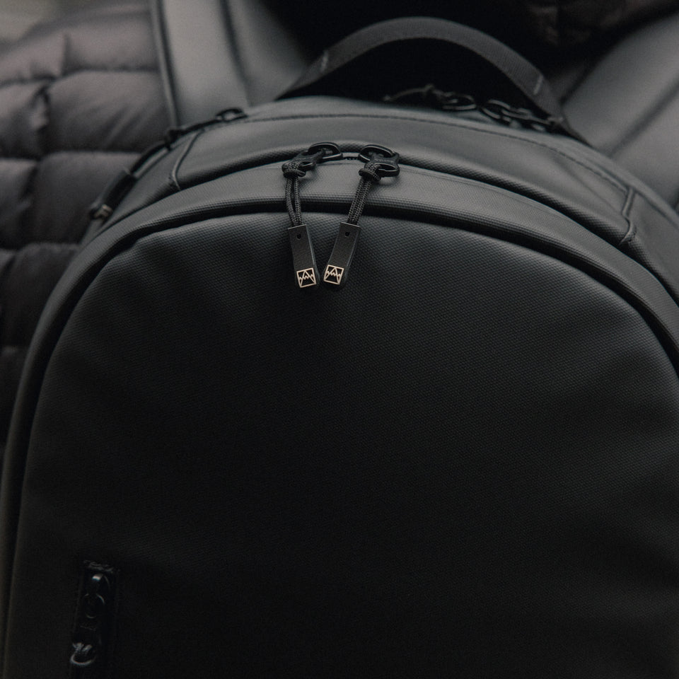 A close up of the top and zips of an Everyday Backpack 15L in All Black