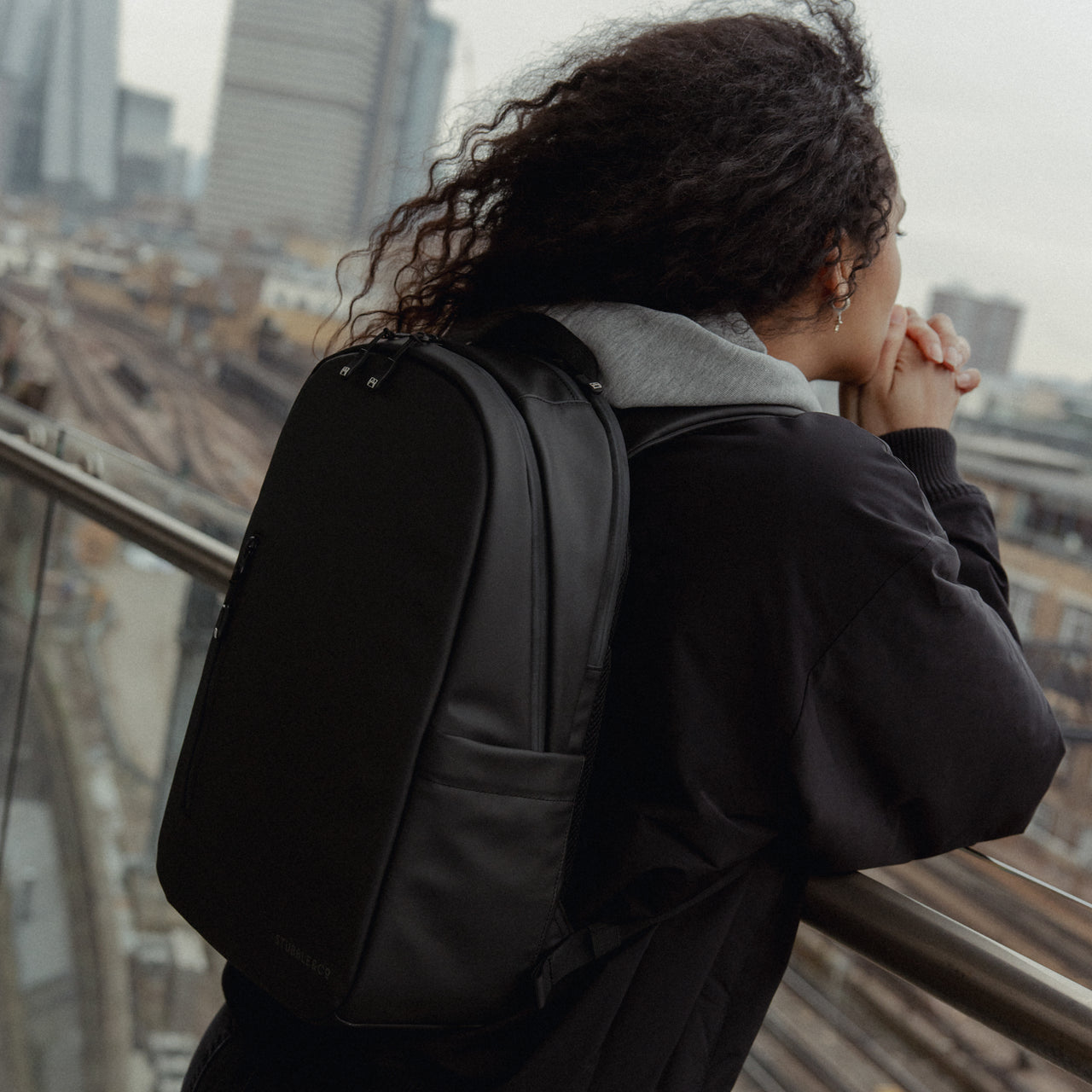 A woman wearing an Everyday Backpack 15L on her back in All Black