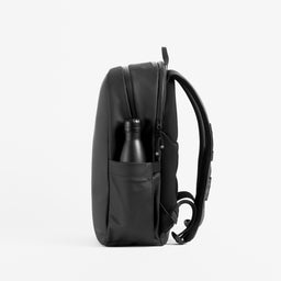 Stubble and Co Everyday Backpack in All Black side view with bottle