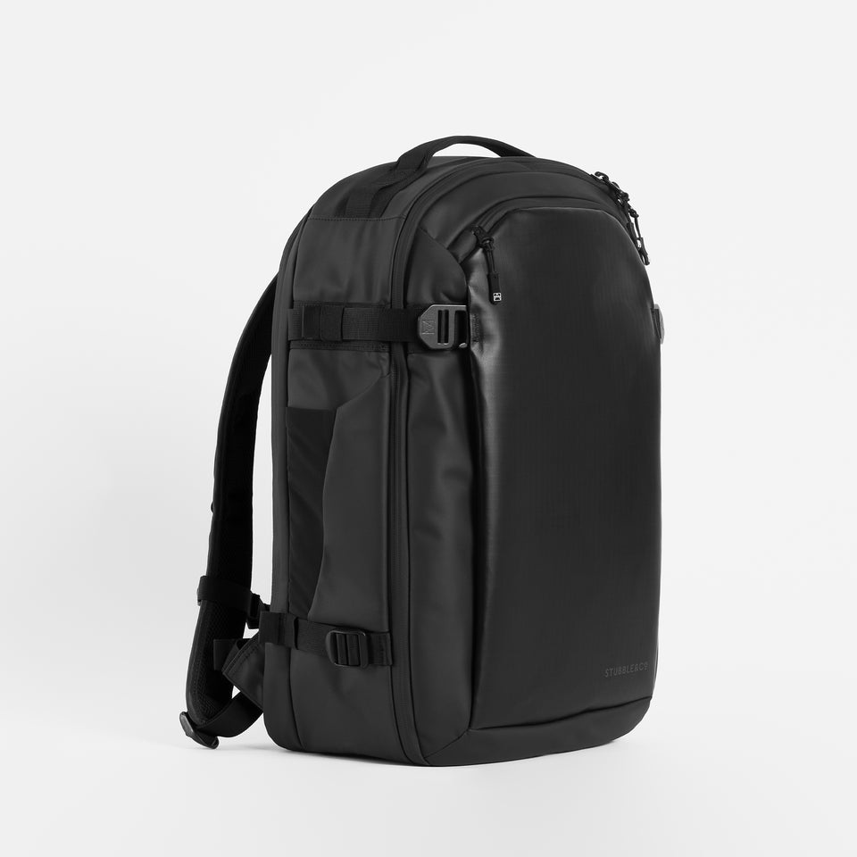 A studio shot of the front of the Hybrid Backpack 30L at a side angle in All Black