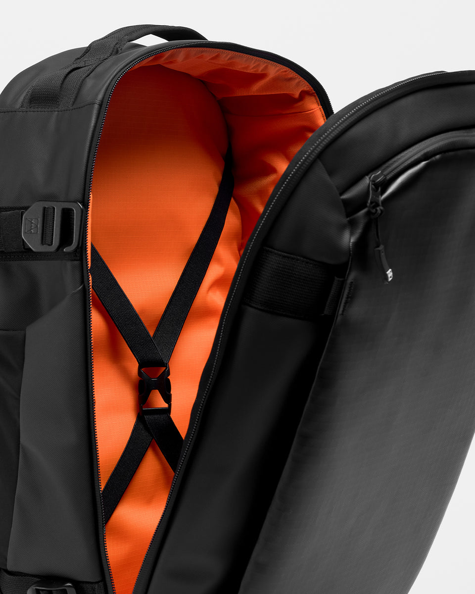 A studio shot of the Hybrid Backpack 30L and its interior capacity and elasticated straps