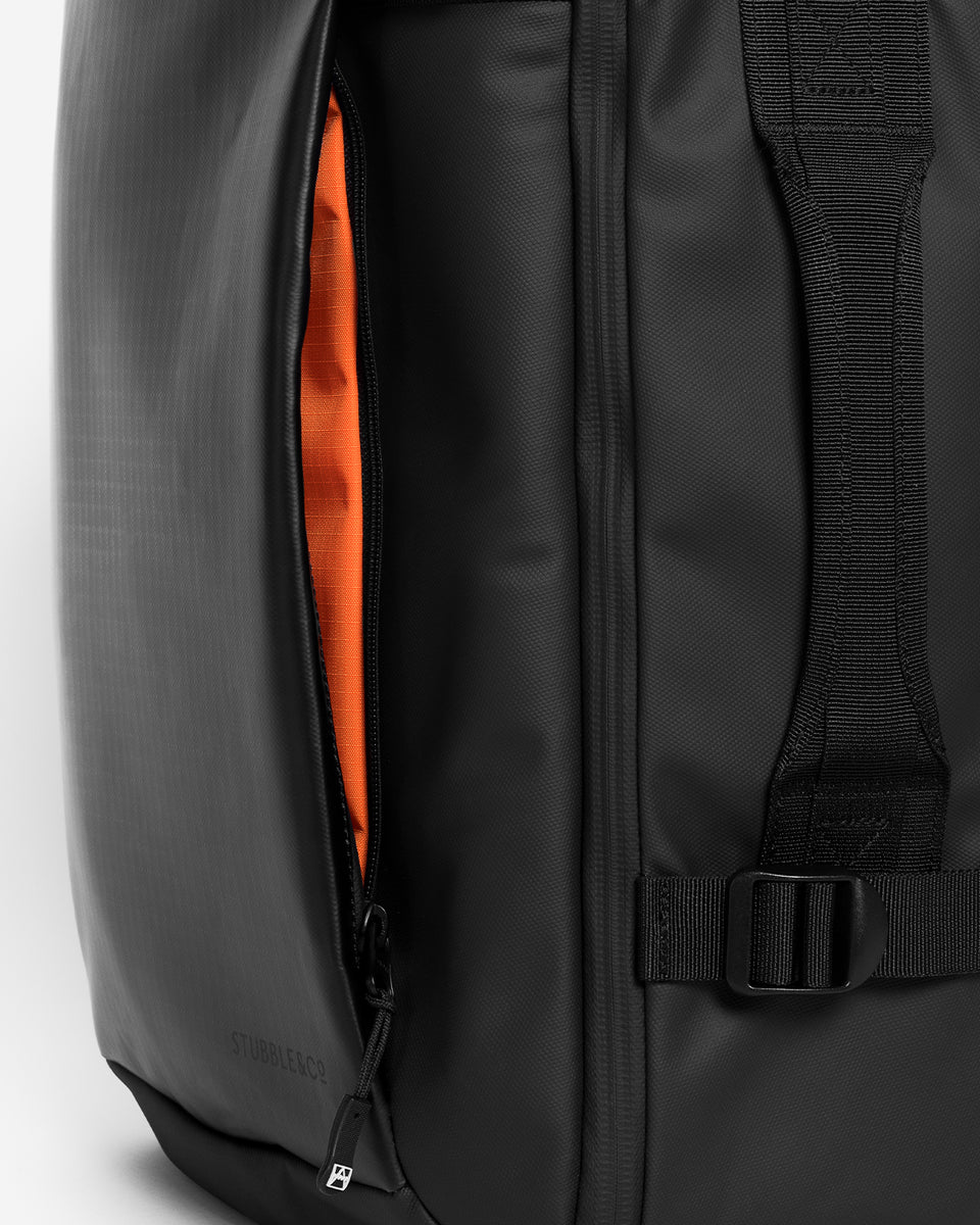 A studio shot of the Hybrid Backpack 30L and its exterior front pocket