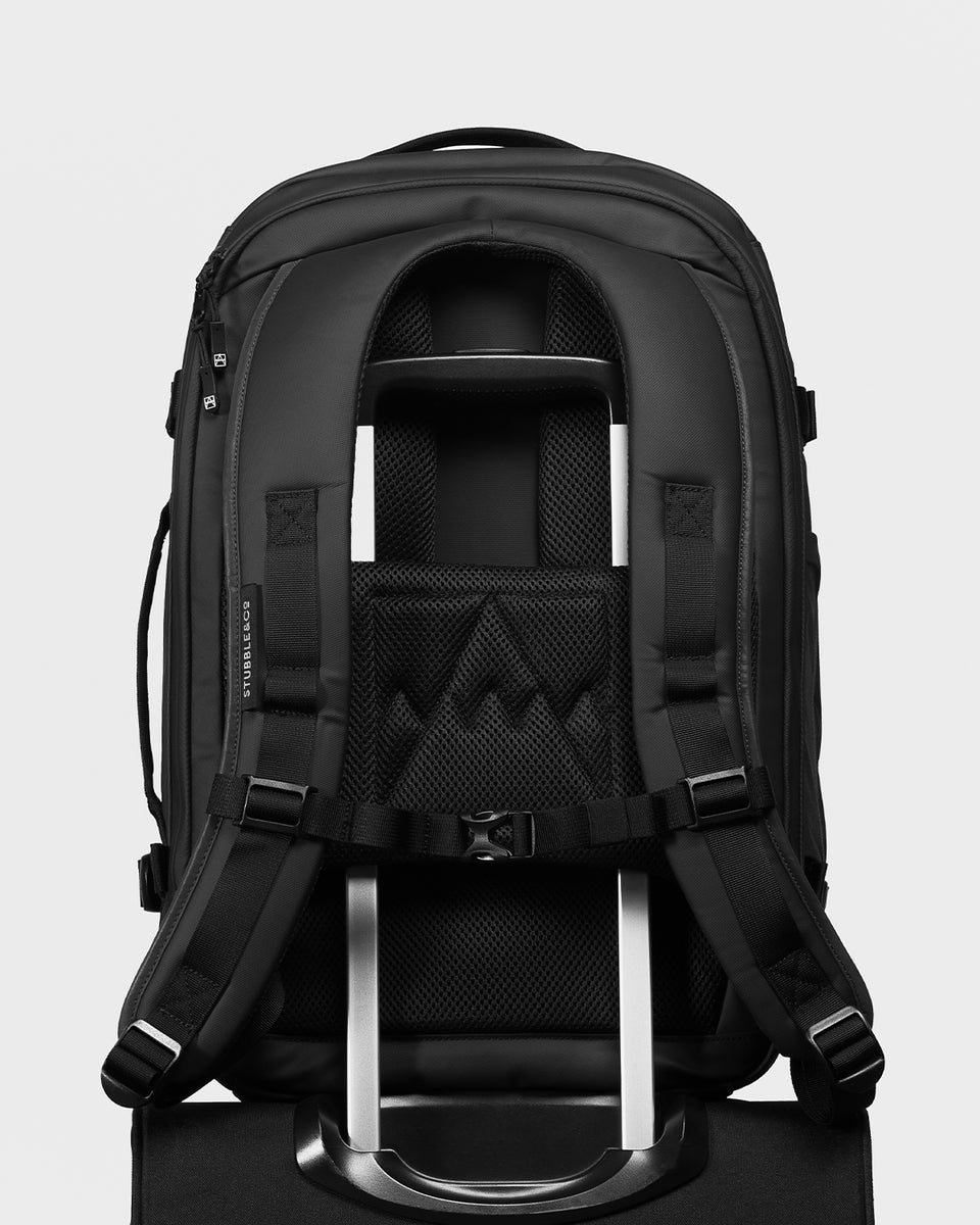 A studio shot of the Hybrid Backpack 30L and its luggage sleeve