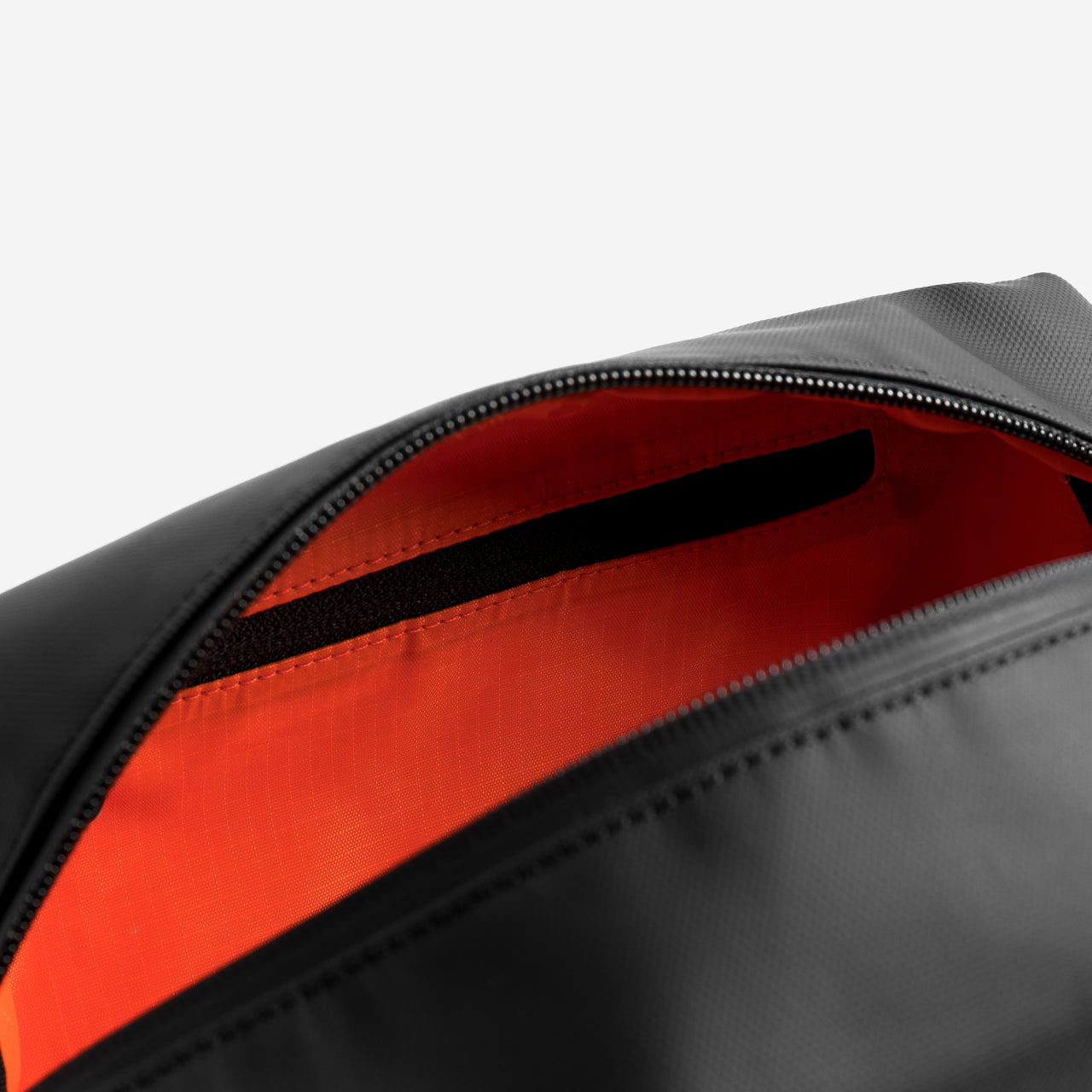 A studio shot of the interior and orange lining of a wash bag [All variants]