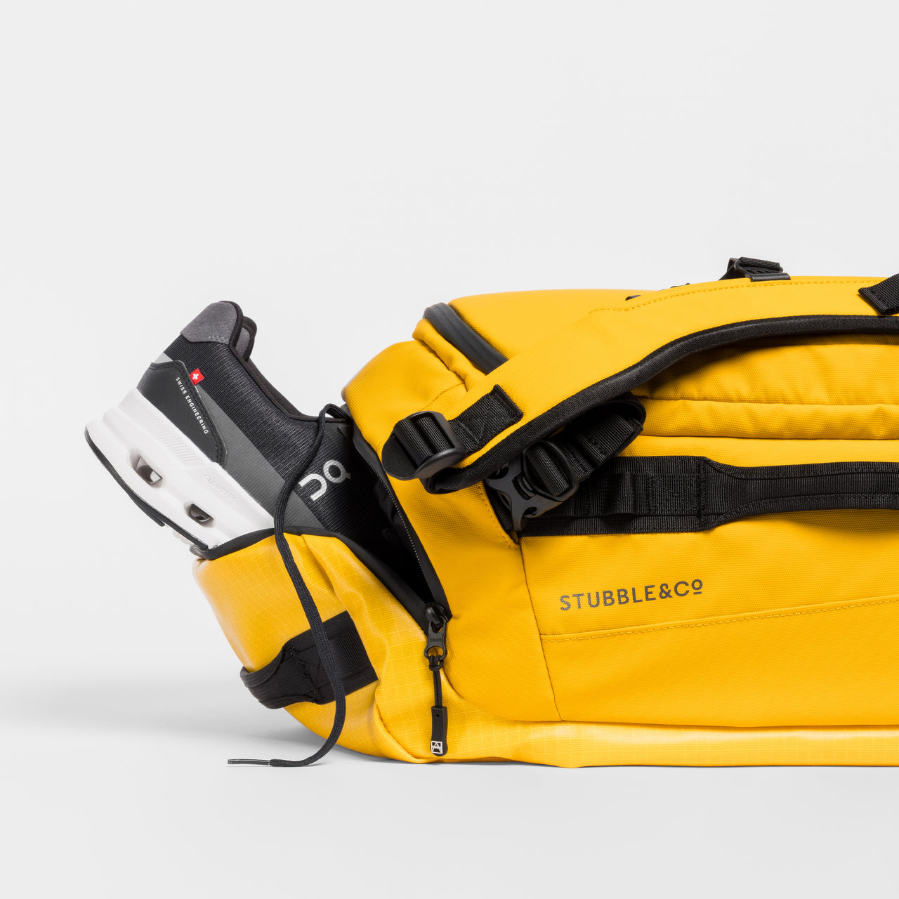 A studio shot of the shoe compartment in a Kit Bag 30L in Yellow