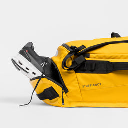 A studio shot of the shoe compartment on a Kit Bag 40L in Yellow