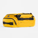 A studio shot of the Kit Bag 40L in Yellow showing the top and side grab handle