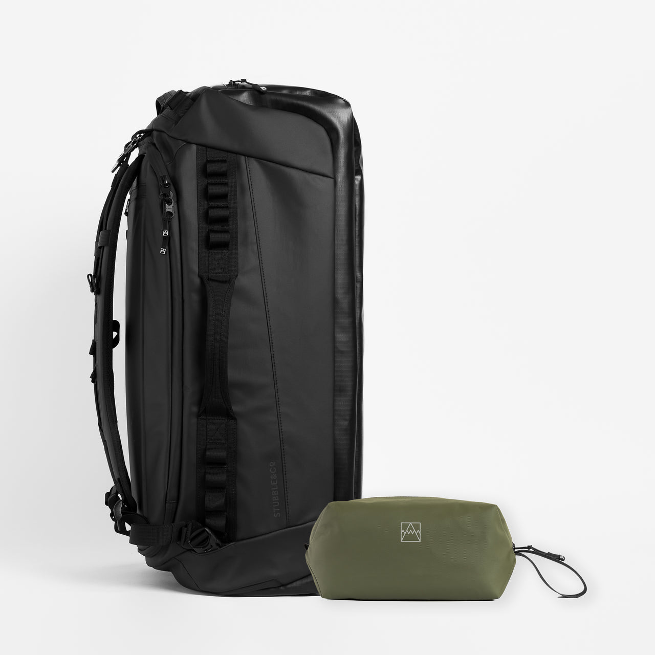 A studio shot of the Kit Bag 65L in All Black / Urban Green Wash Bag bundle