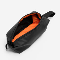 A studio shot of the orange lining and pockets of the pencil case in All Black