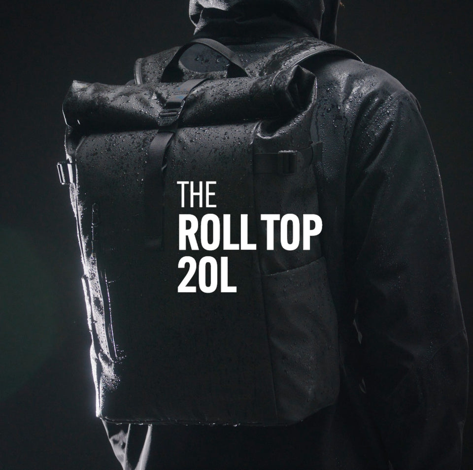 The Roll Top 20L Backpack in All Black showing product features and benefits, also in Tasmin Blue, Urban Green, Concrete, Arctic White, Sand, Ember Orange, Yellow