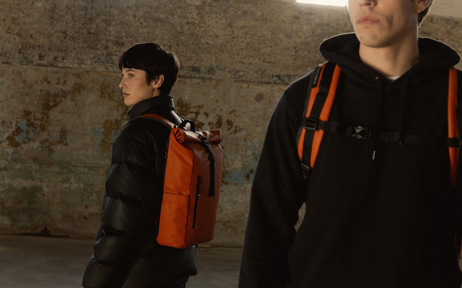 a man and woman wearing rust roll tops on their backs