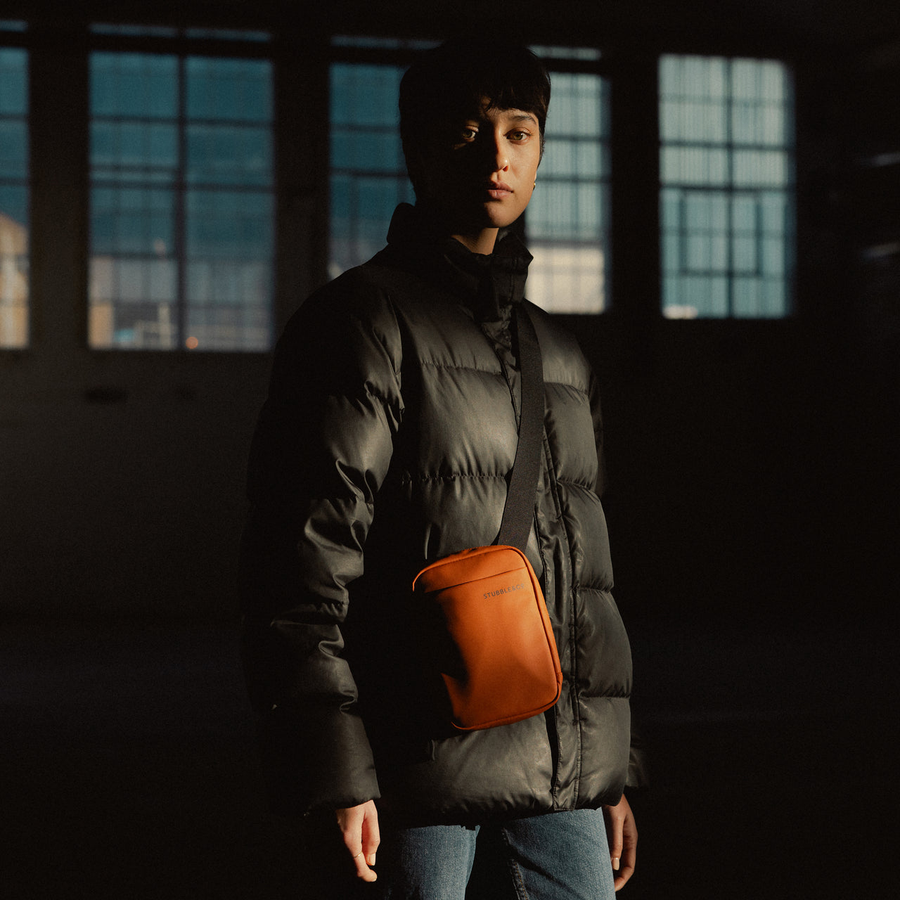 A woman wearing a Shoulder bag in Rust 