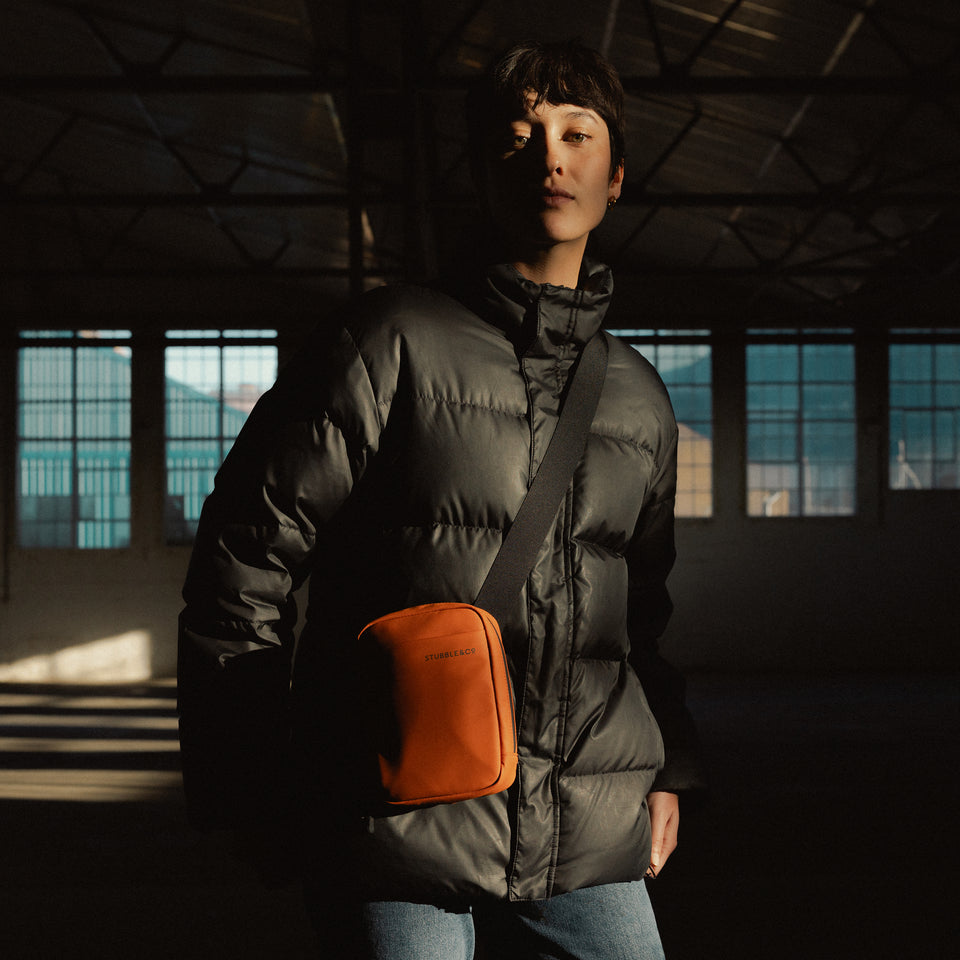 A woman wearing a Shoulder Bag in Rust