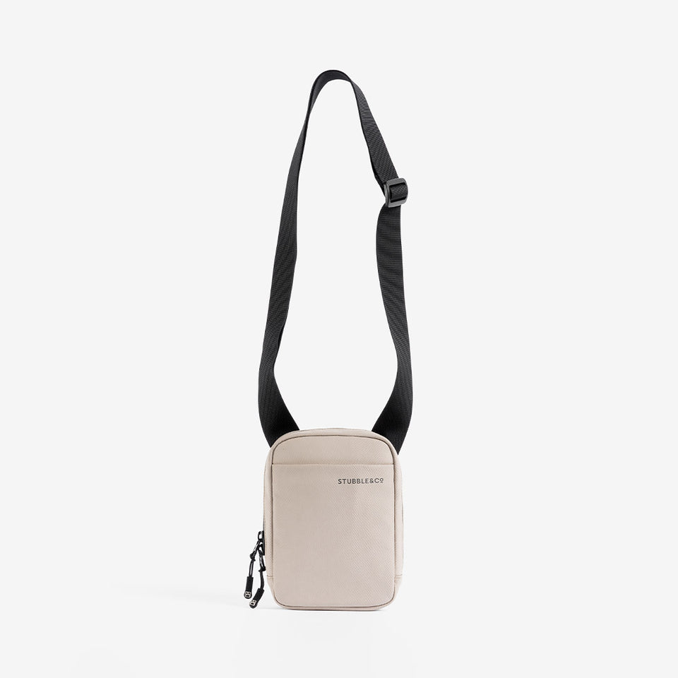 a studio shot showing the long strap on a Sand shoulder bag