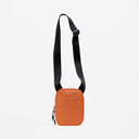 A studio shot of the Shoulder Bag in Rust with the strap hanging