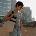 a woman walking whilst wearing a Sand Tote Bag on her shoulder