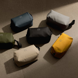 A creative studio shot of all of the Wash Bag colours including the Yellow