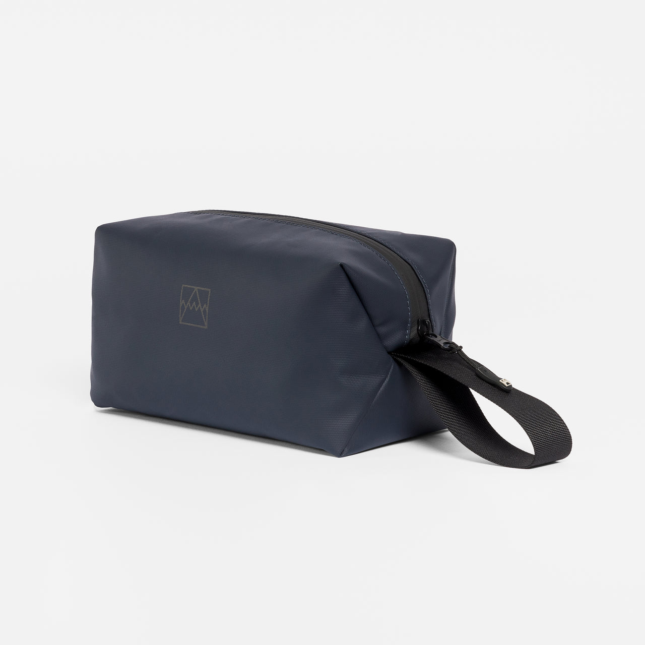 A studio shot of the side and grab handle of a Midnight Blue Wash Bag