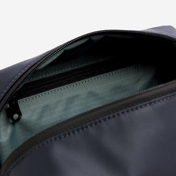 A studio shot of the interior pockets and blue lining in a Midnight Blue Wash Bag