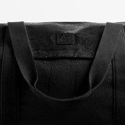 A studio shot of water on the water-resistant material of the Weekender Duffel 30L in All Black