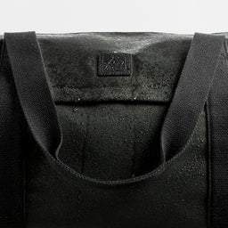 A studio shot of water on the water-resistant canvas material used for the Weekender 30L in Pirate