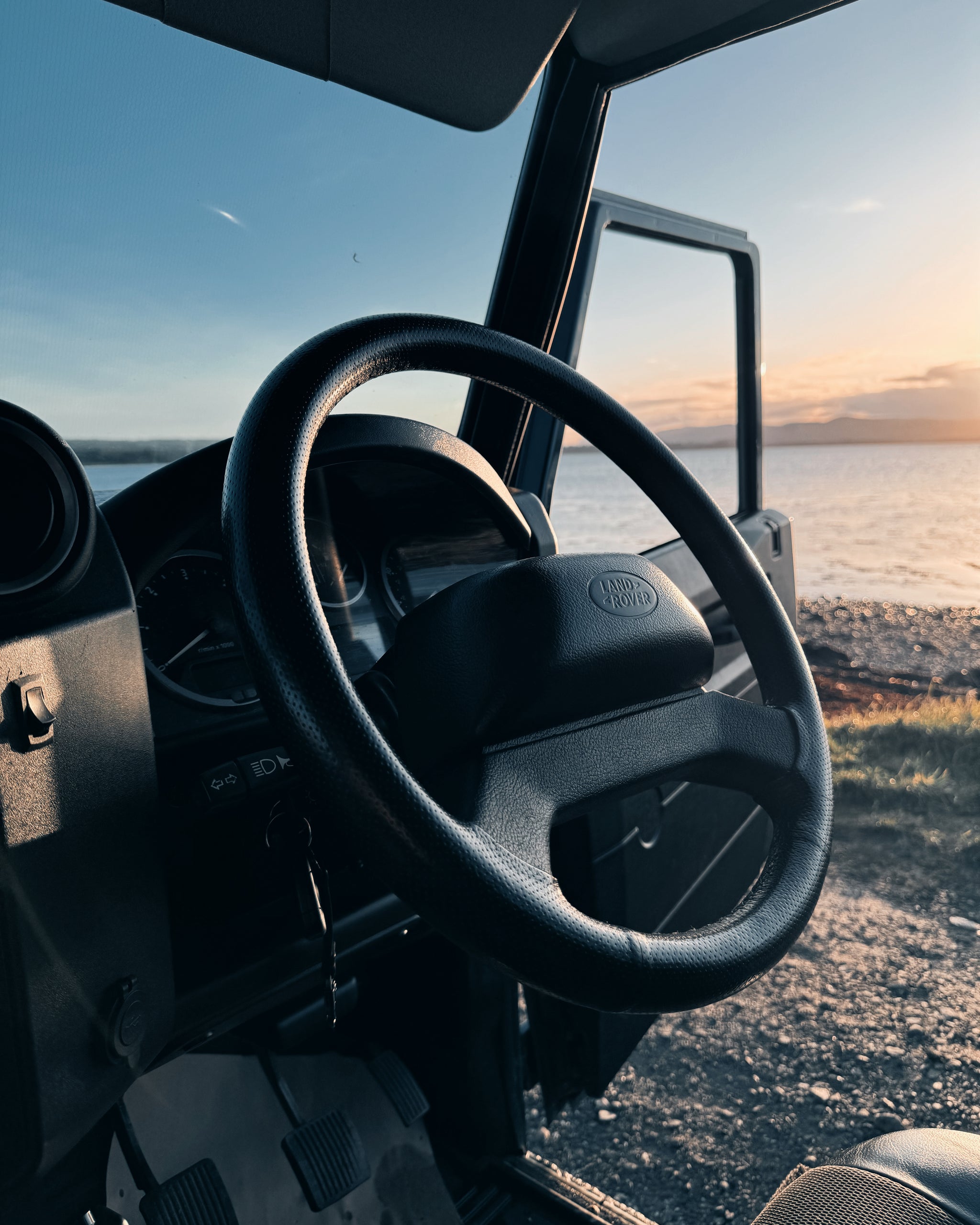 A shot of the inside of a Land Rover, including the steering wheel.