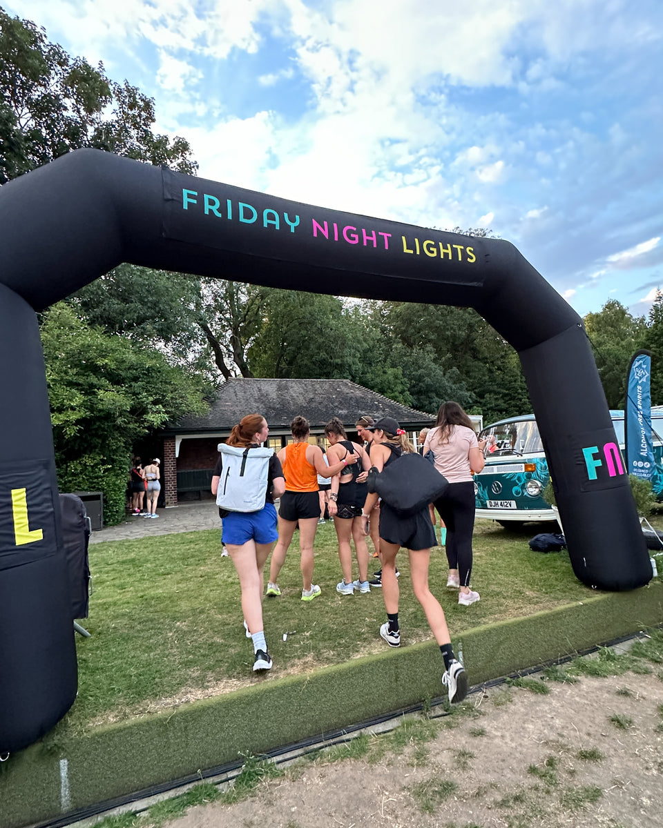 women crossing the Friday Night Lights event with one wearing a Roll Top on her back